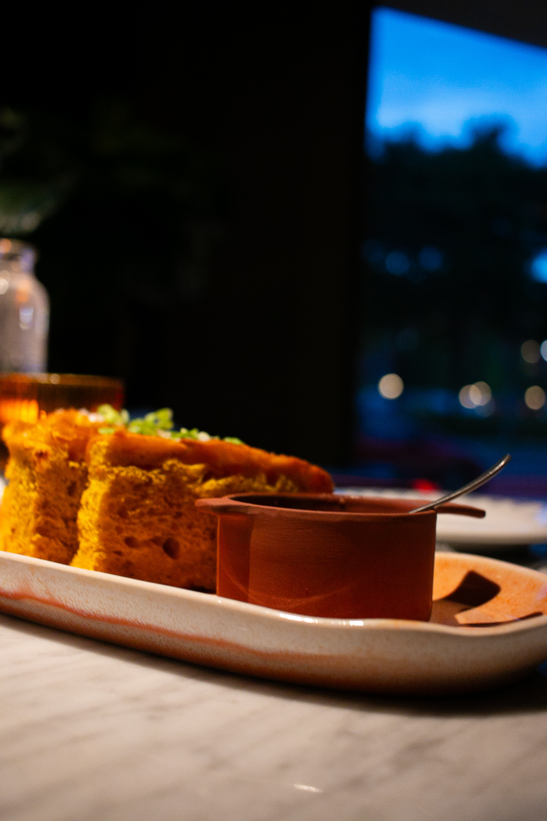 Turmeric focaccia with a terracotta pot of anchovy oil at AMA