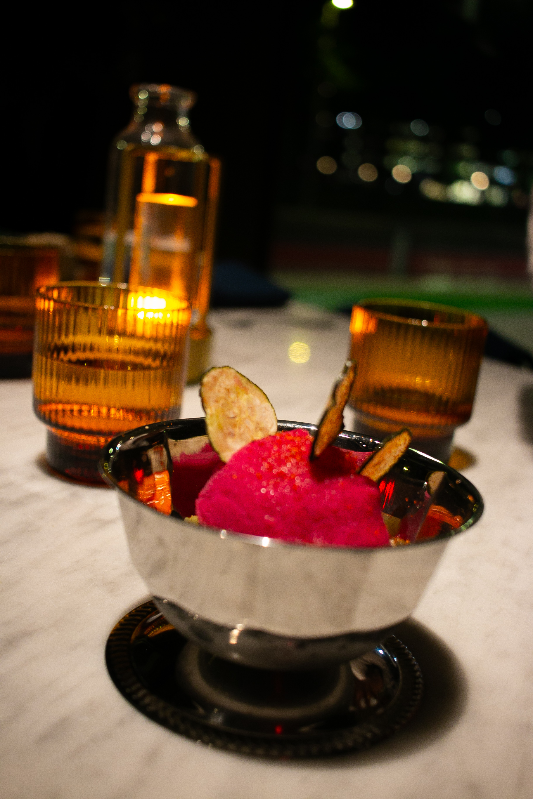 Bright pink prickly pear sorbet in a silver footed bowl at AMA